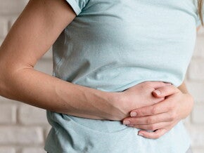 Foto de mulher com as mãos na barriga