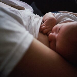 Mother breastfeeding baby in dark Mother breastfeeding baby in dark