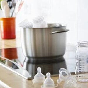 Preparing baby formula in the kitchen. Preparing baby formula in the kitchen.